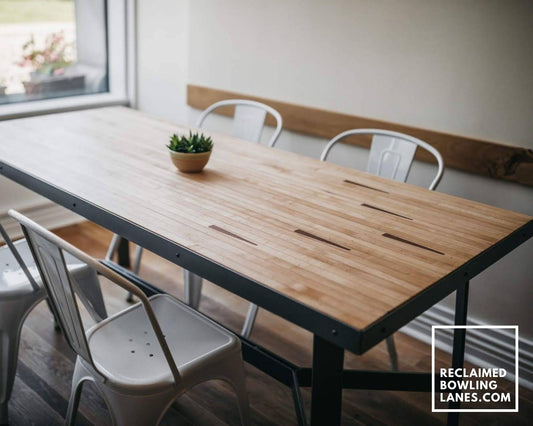dining table made from vintage maple bowling alley wood with arrows